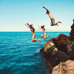 Kids cliff jumping into the sea