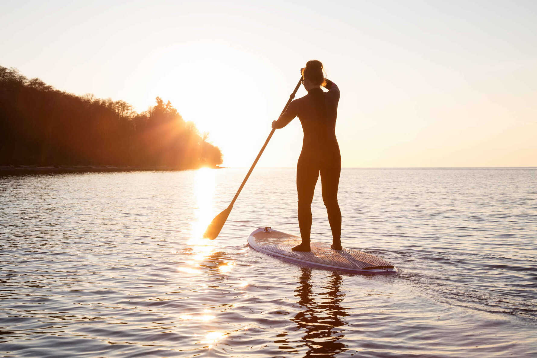 a girl on a paddleboard in the sea