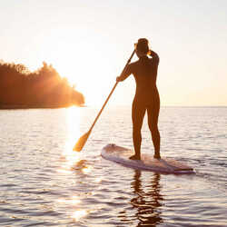 a girl on a paddleboard in the sea