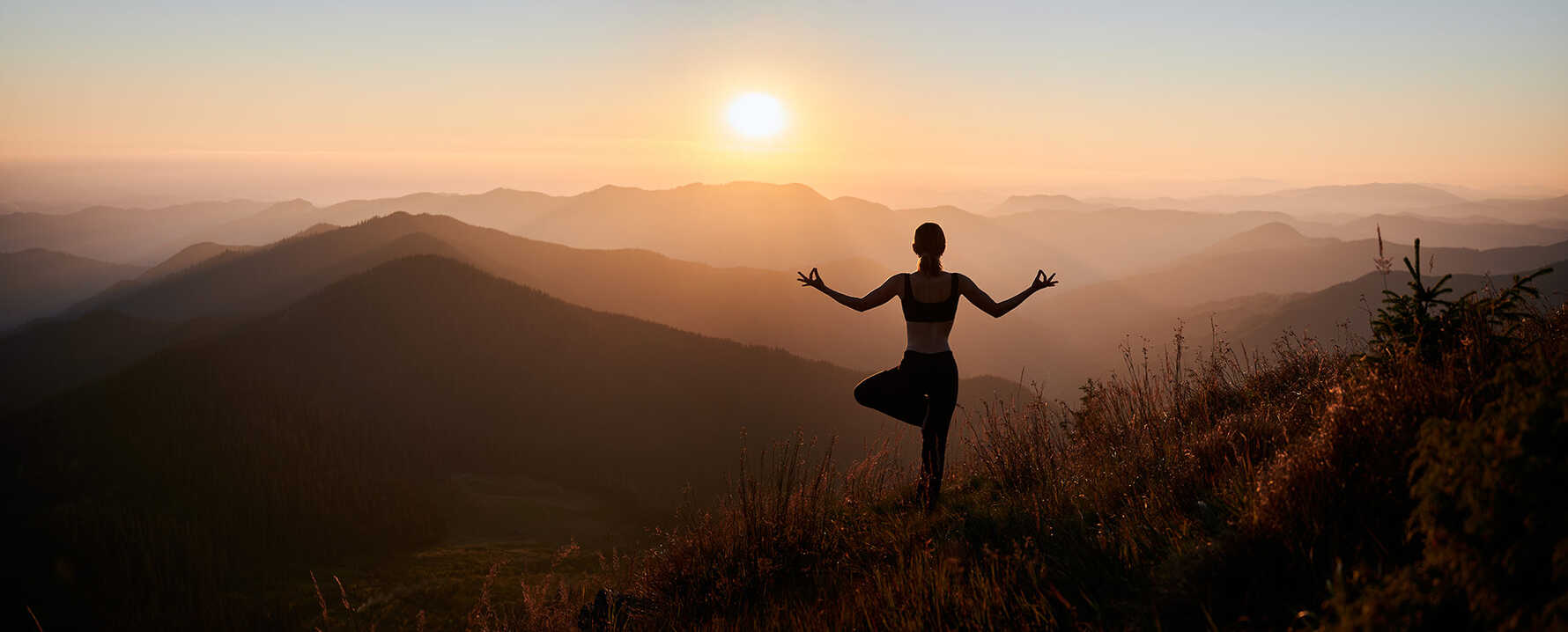A person doing yoga in the mountains