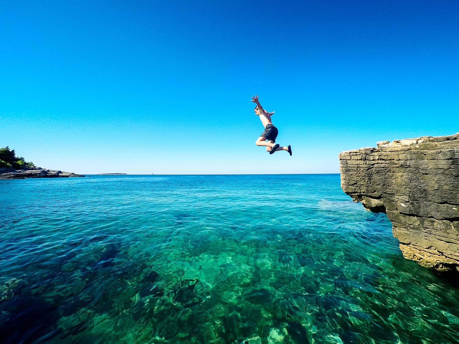 Photo showing a boy cliff jumping