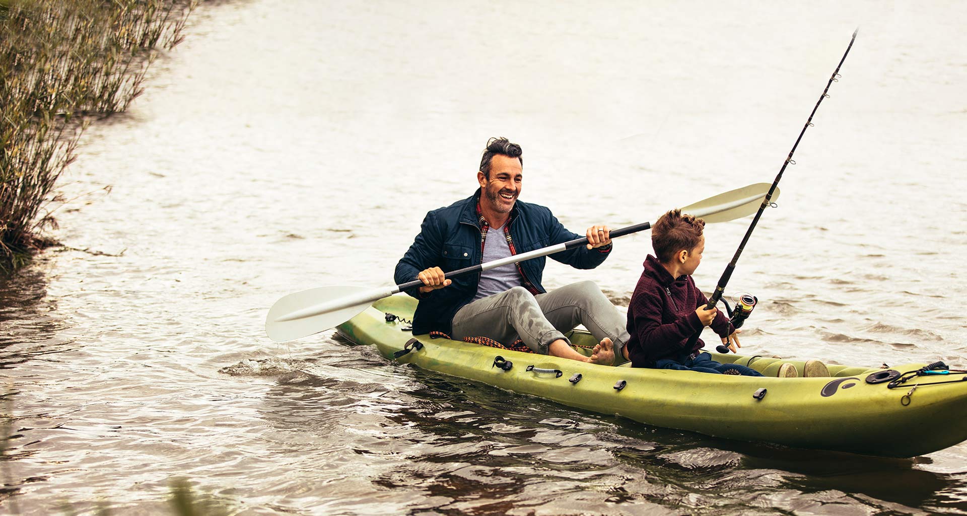 father and son on a canoe in a river